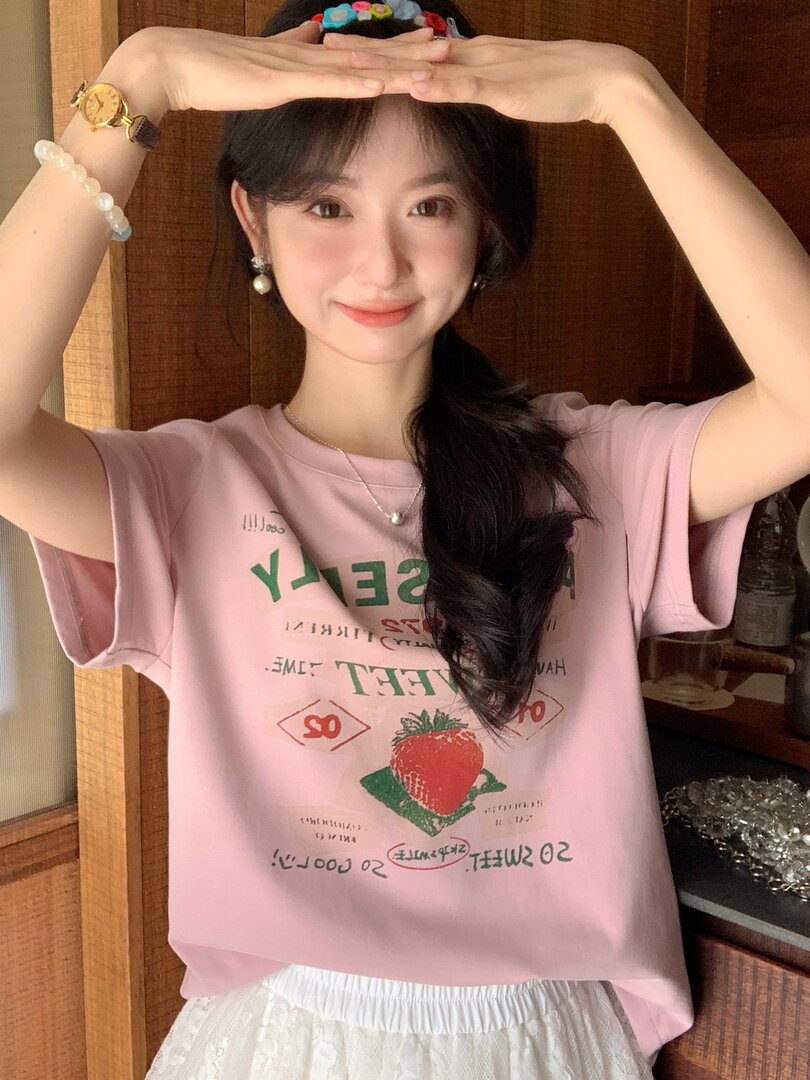 Pink graphic short-sleeve T-shirt worn by a woman