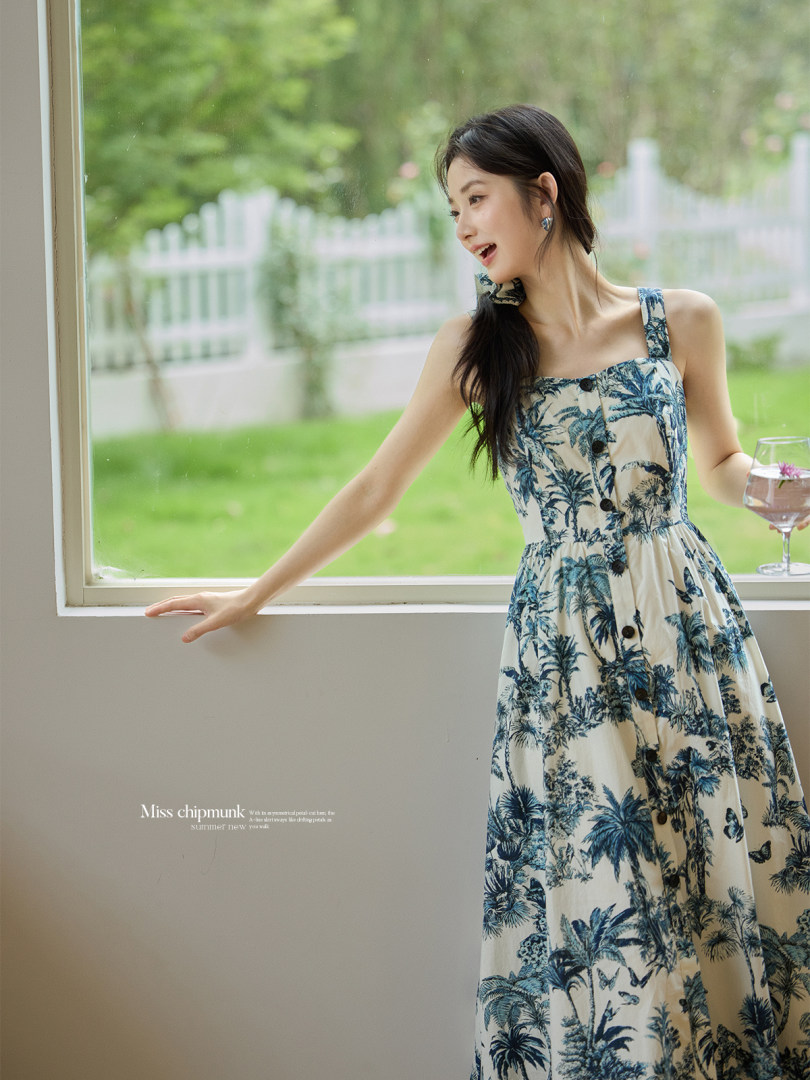 Woman wearing a tropical print sleeveless maxi dress