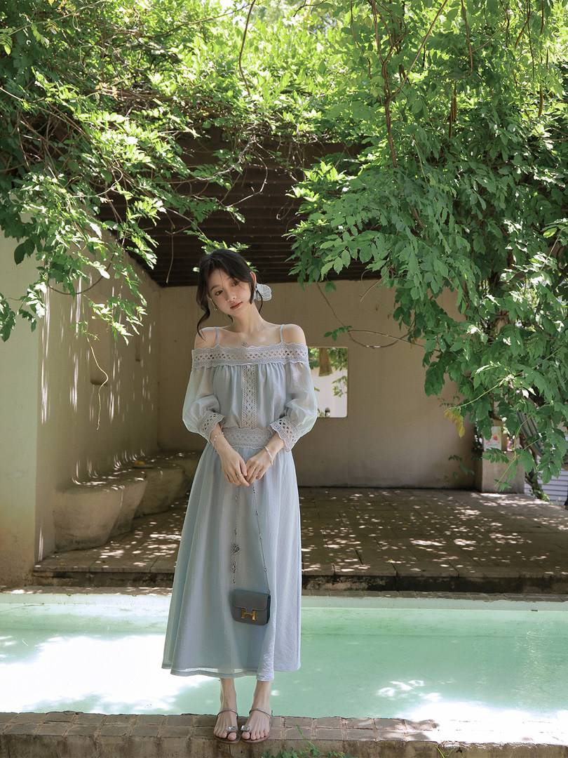 Light blue off-shoulder dress worn by a model outdoors