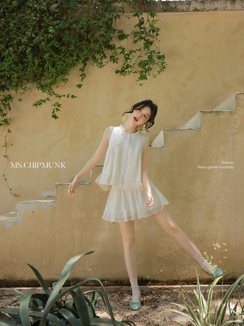 White lace two-piece outfit worn by a model outdoors