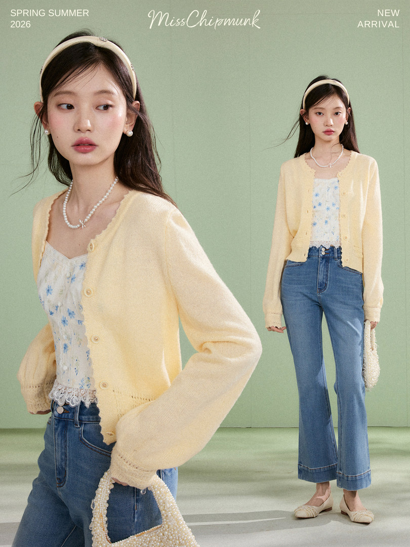 Model wearing a pale yellow cardigan over a floral top with blue jeans