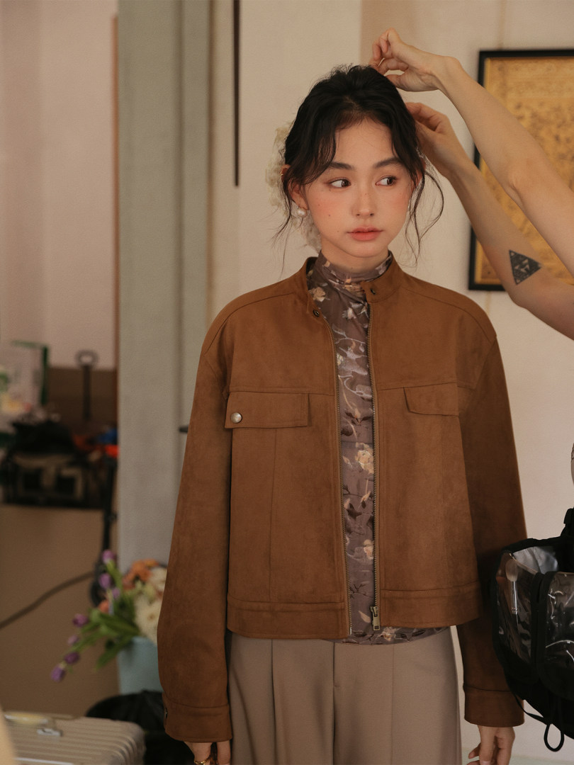 Brown zip-front jacket worn by a model
