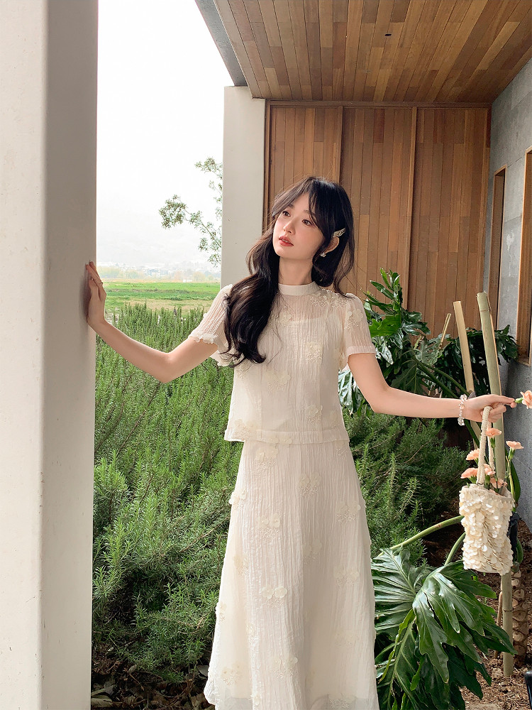 Woman wearing a white sheer dress set outdoors