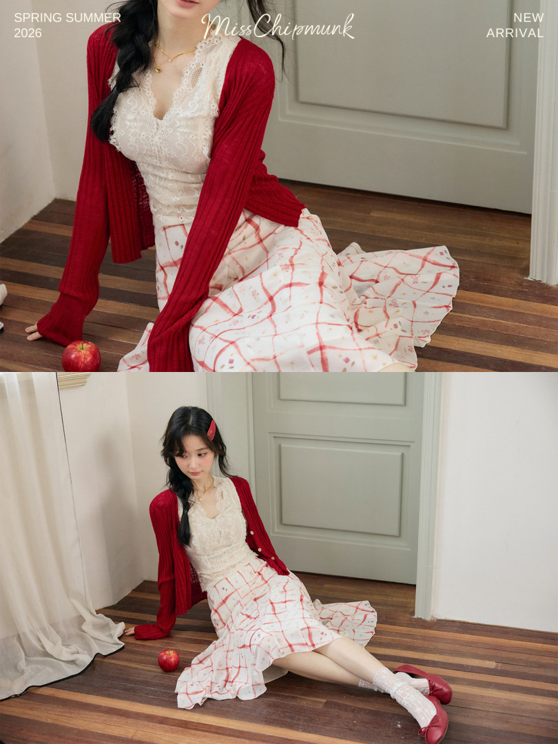 Woman wearing a red cardigan over a white lace top and patterned skirt