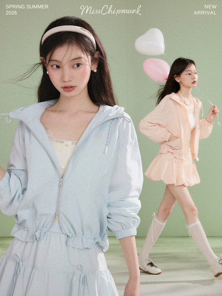 Pastel hooded jacket and skirt outfit worn by models in a spring-summer promotional image