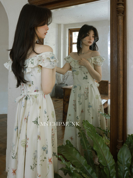 Floral off-shoulder dress worn by a model in front of a mirror
