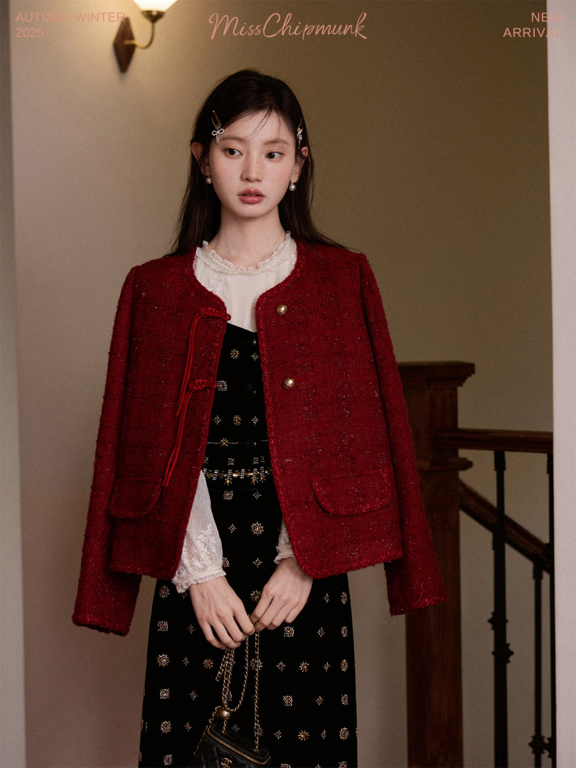 Model wearing a red textured jacket over a black dress