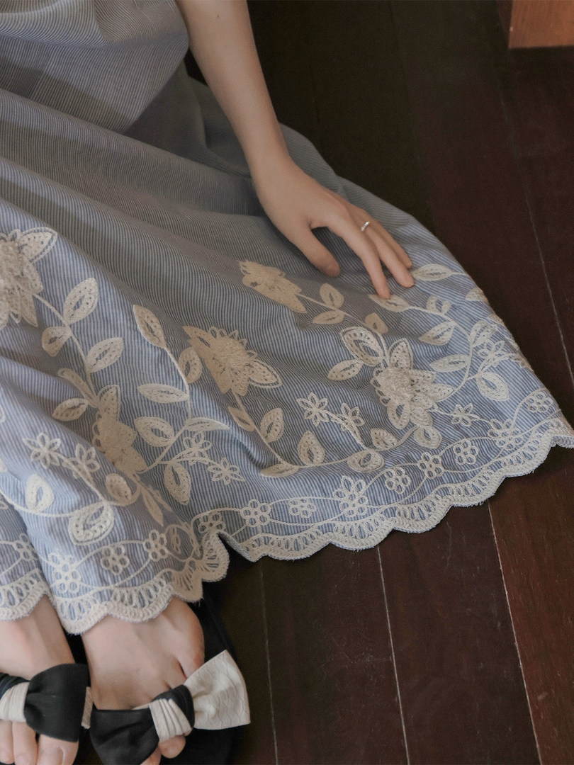 Light blue striped lace-trimmed skirt worn by a model