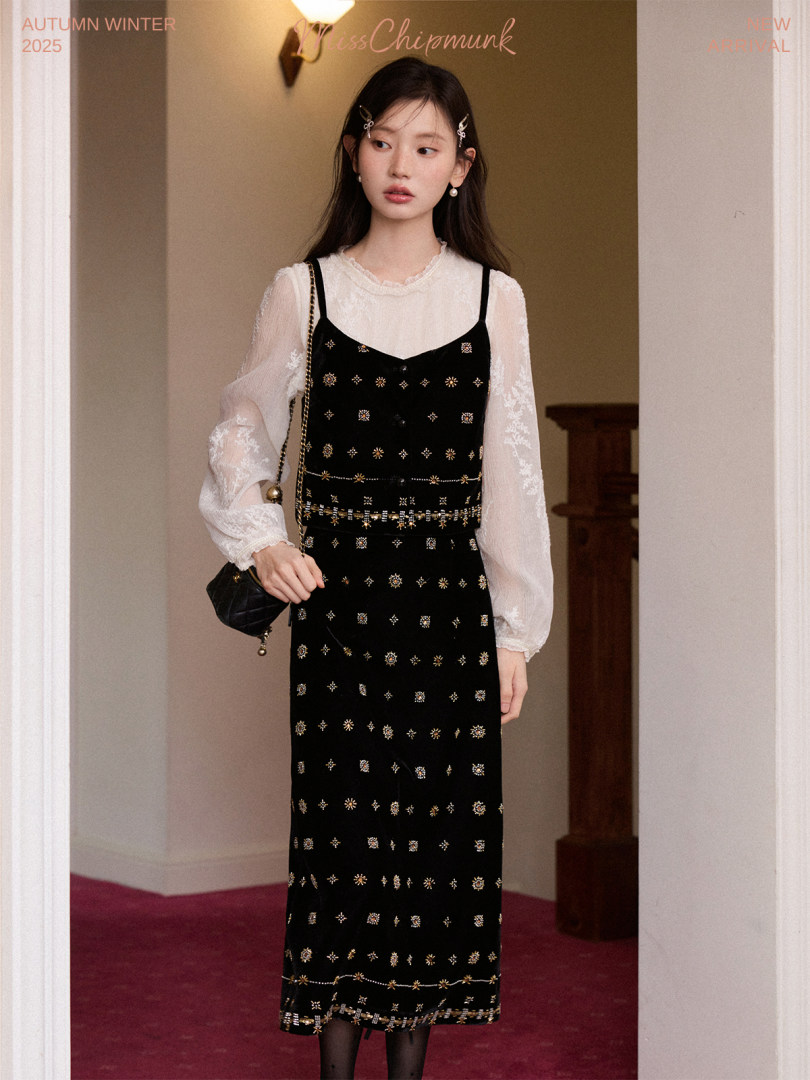 Model wearing a black embellished dress layered over a sheer blouse