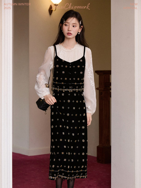 Model wearing a black embellished dress layered over a sheer blouse