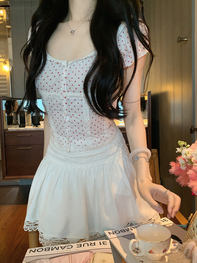 White polka dot dress with lace details worn by a model