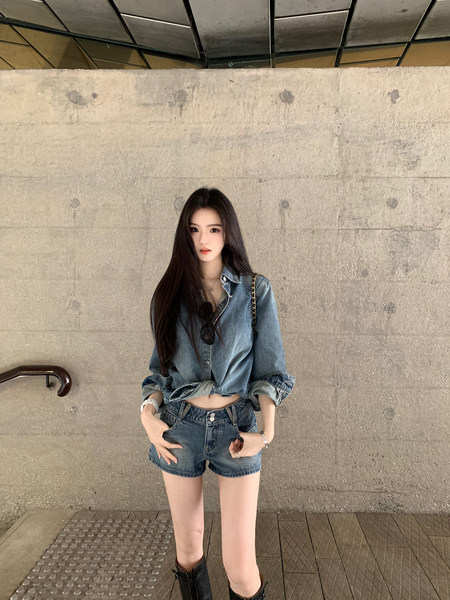Woman wearing denim shirt and shorts with black boots