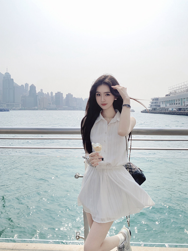 Woman wearing a white dress by the waterfront