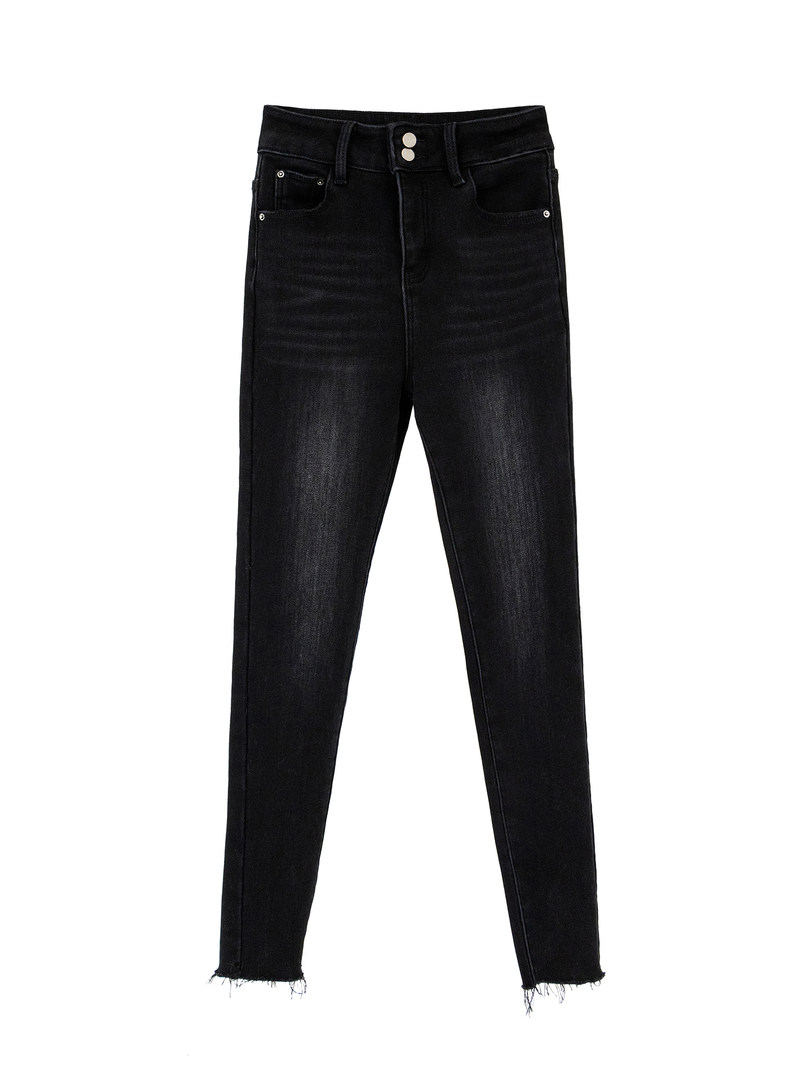 Black skinny jeans with frayed hem on white background