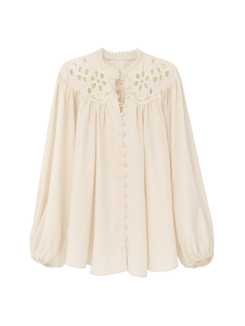 Cream-colored blouse with lace detailing and button front