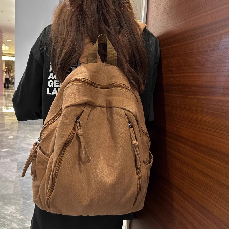 奥莱新款秋冬帆布书包女大学生设计感户外旅行背包男原宿小号双肩