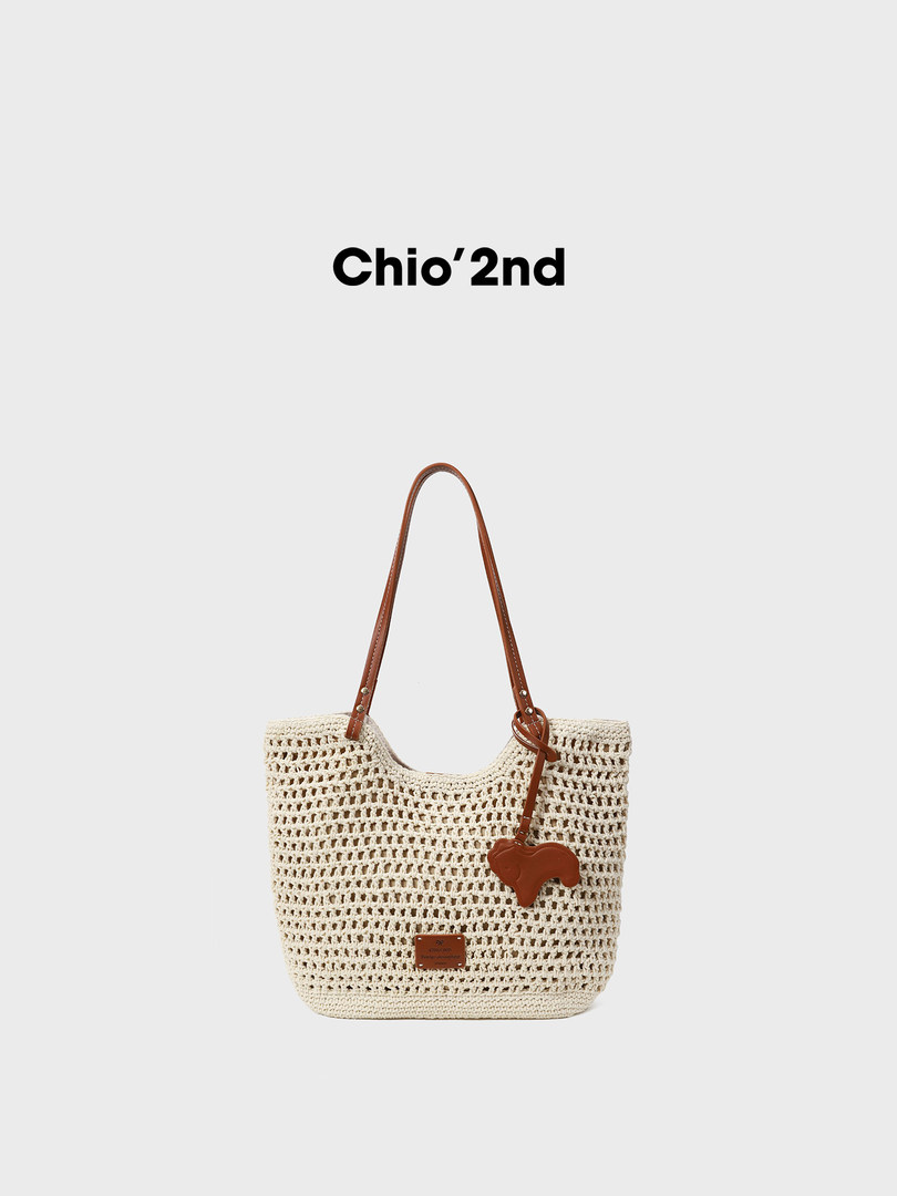 Crocheted cream tote bag with brown leather straps and charm