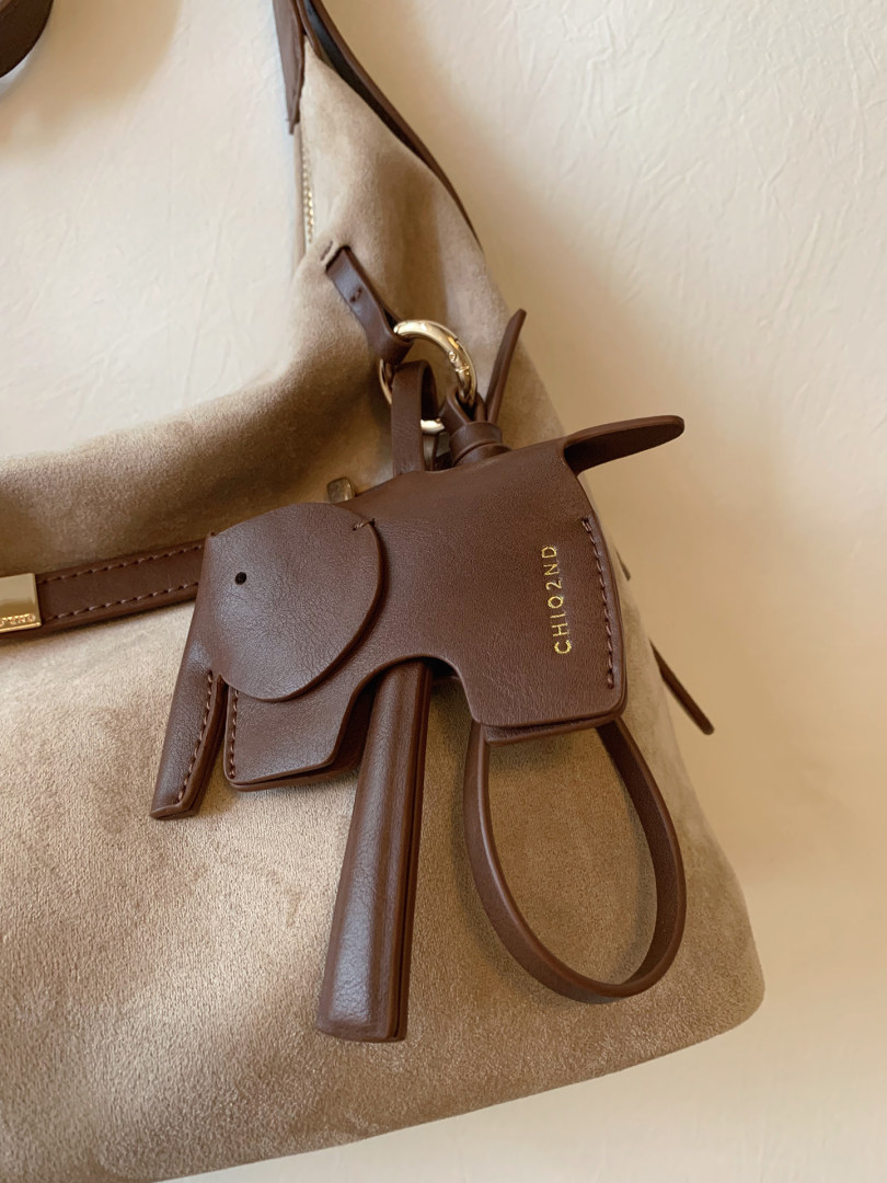 Brown leather handbag with long straps and gold logo detail