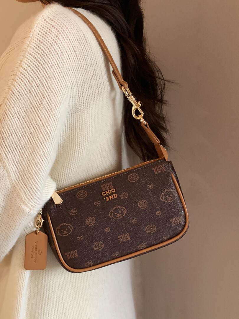 Brown monogram crossbody handbag worn on a model