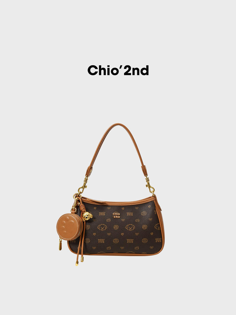Brown monogram shoulder handbag with gold hardware and charm on a white background