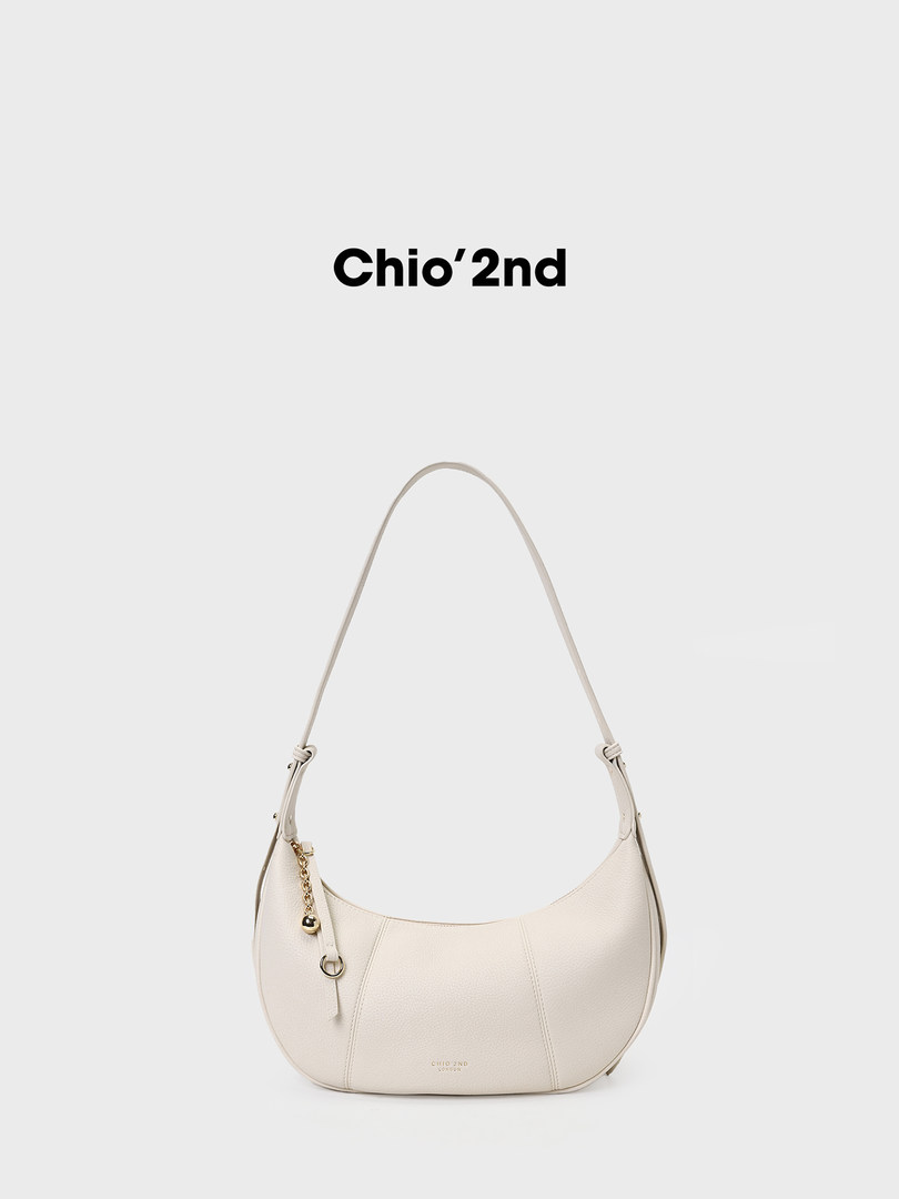 Cream crescent-shaped shoulder bag on a white background