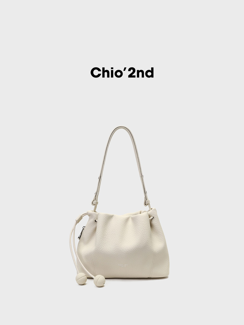 Cream-colored shoulder bucket bag with a long strap and drawstring details