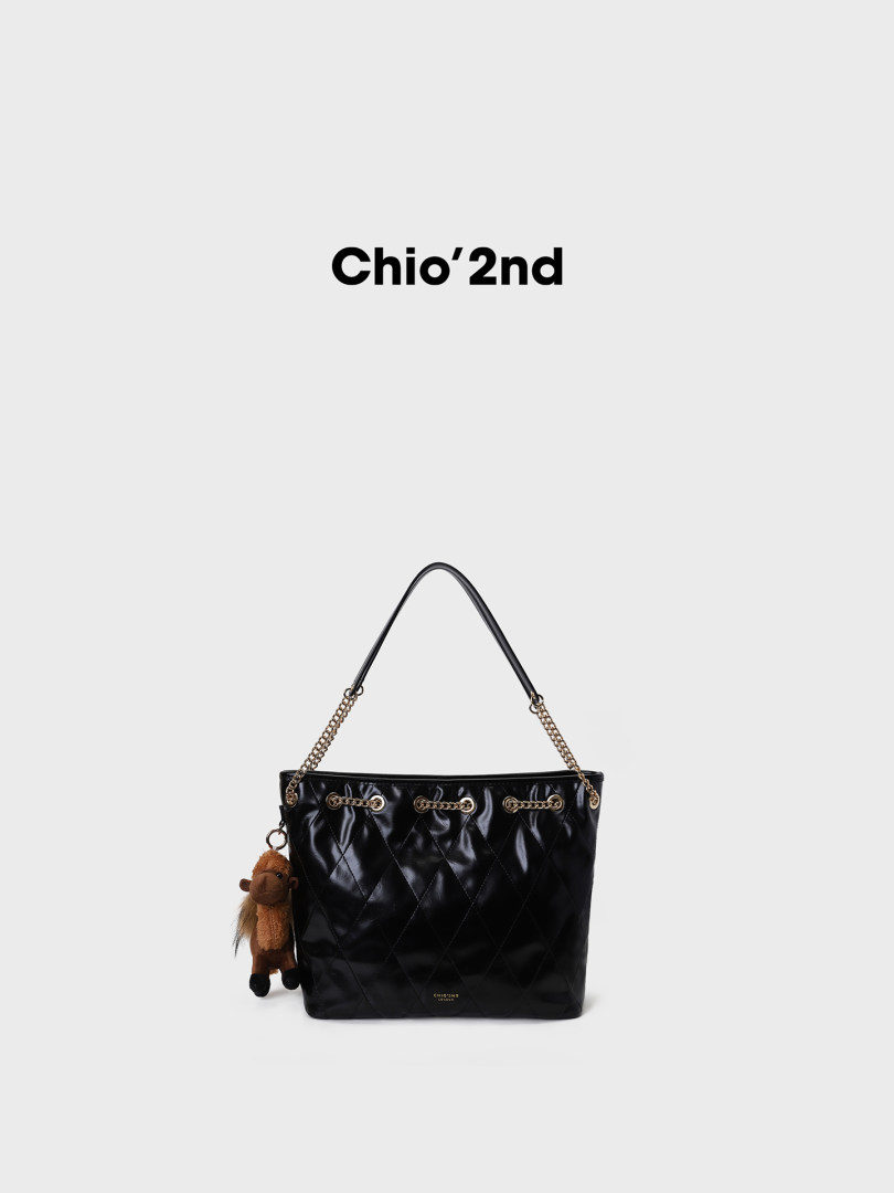 Black quilted tote handbag with chain straps and charm