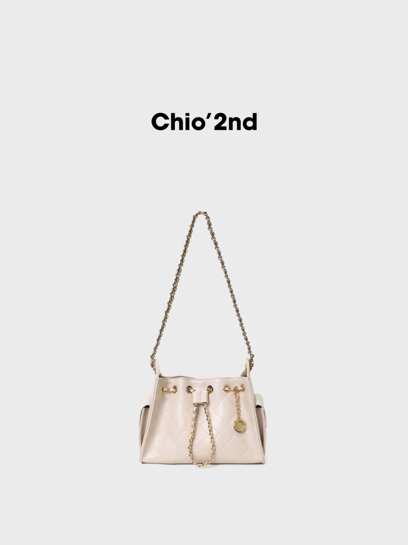 Cream quilted chain-strap handbag on a white background
