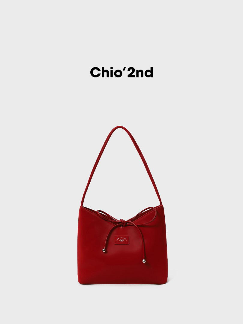 Red shoulder handbag on a white background