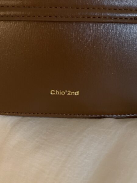 Close-up of a brown leather handbag interior with brand logo