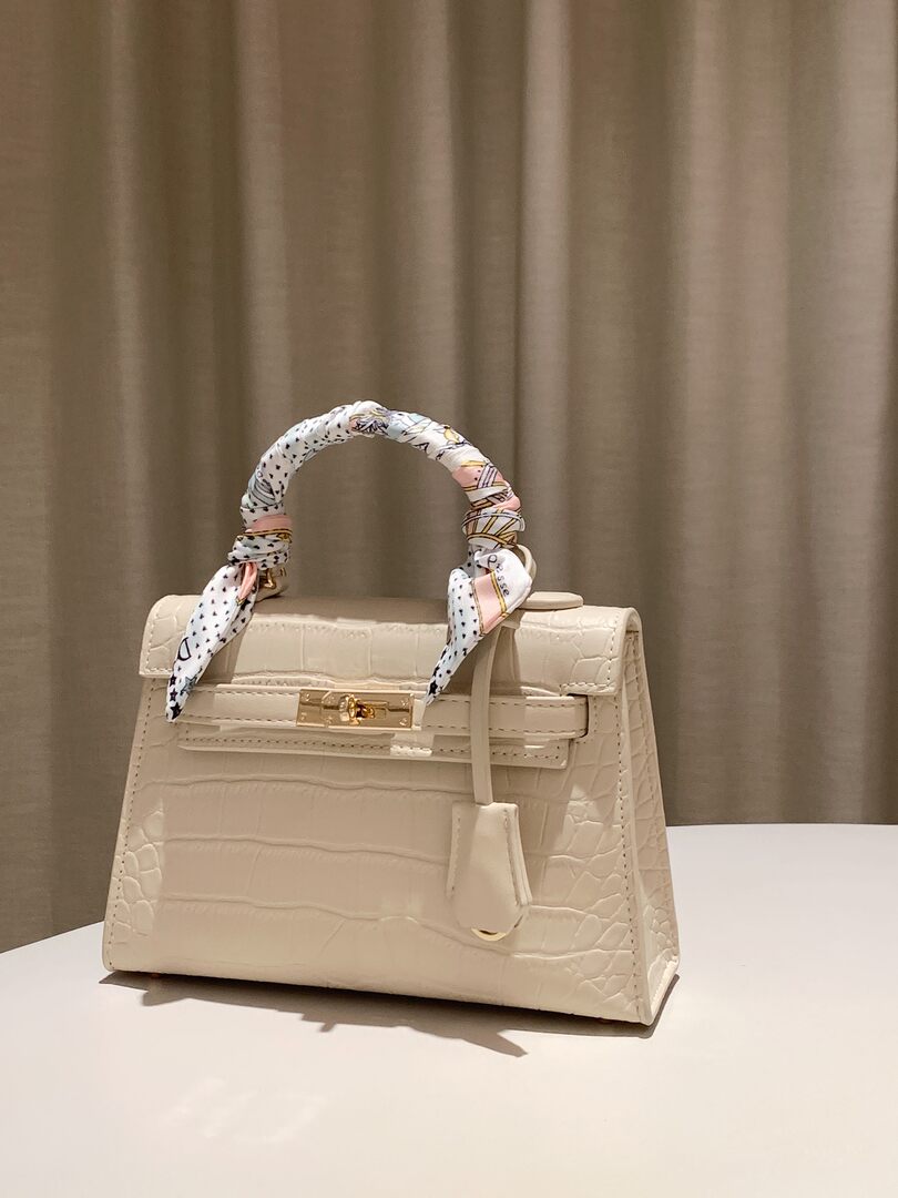 Cream crocodile-textured handbag with scarf-wrapped handle