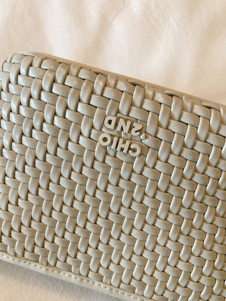 Beige woven handbag or clutch with embossed logo detail