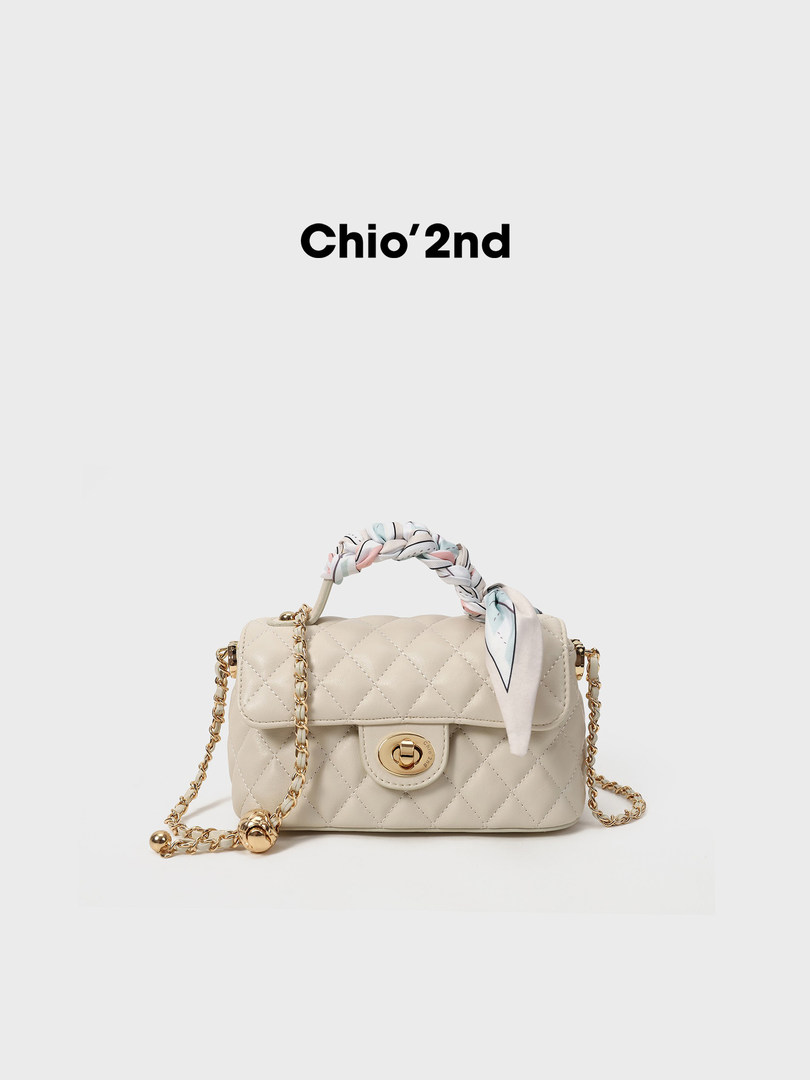 Beige quilted chain-strap handbag with braided handle on a white background