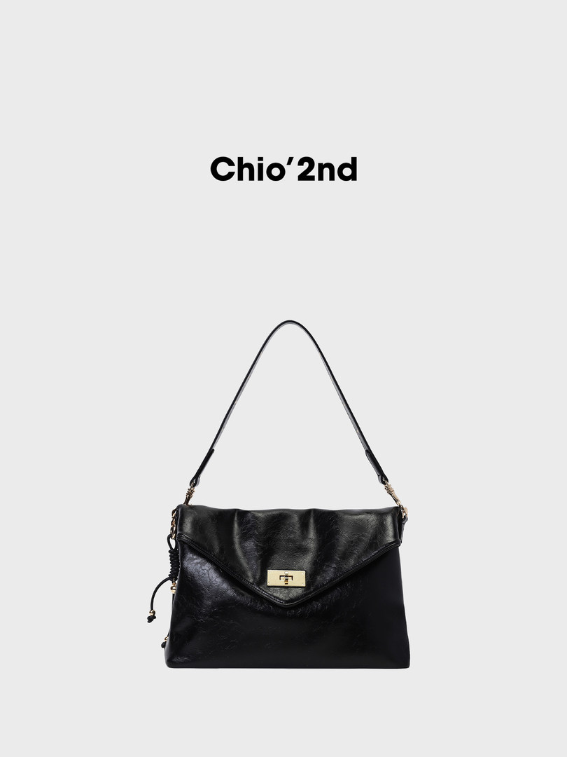 Black leather shoulder bag with gold clasp on a white background