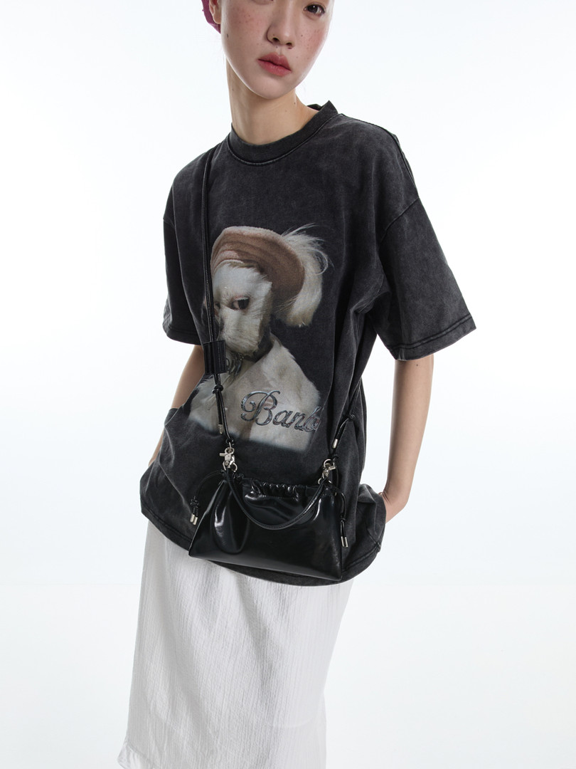 Model wearing a black graphic oversized T-shirt with a dog print