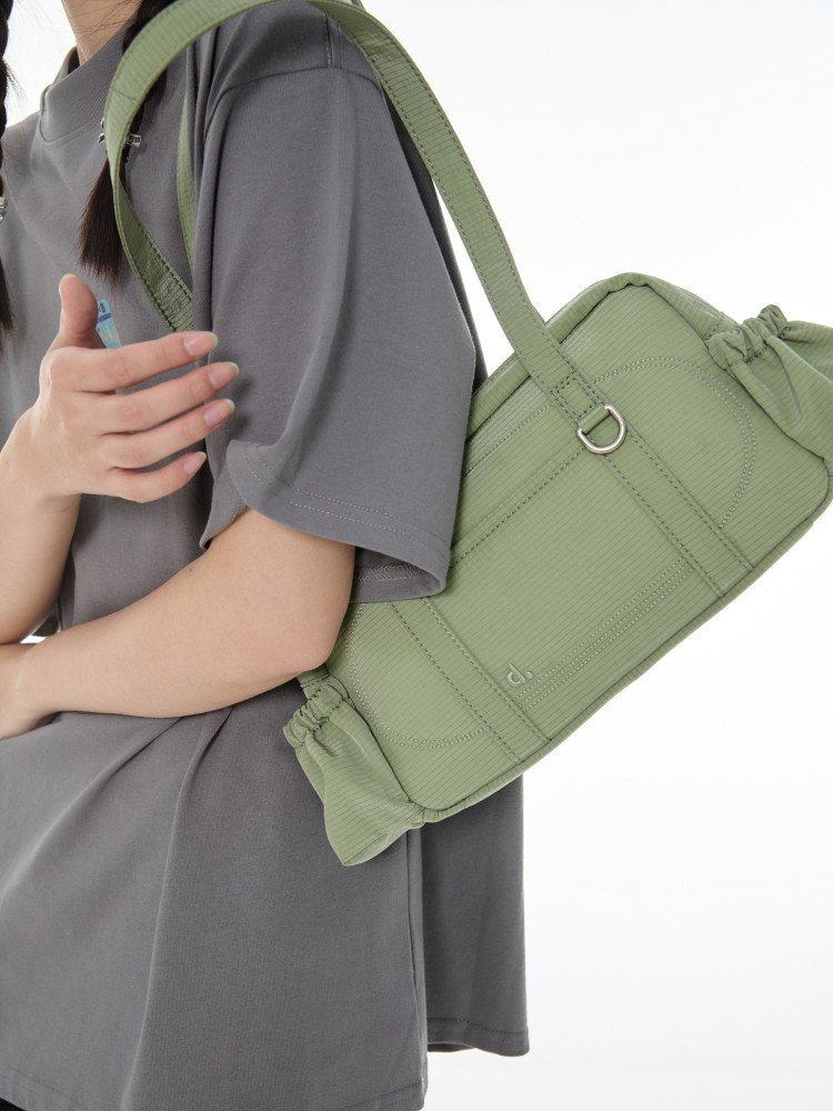 Light green shoulder bag worn crossbody on a person