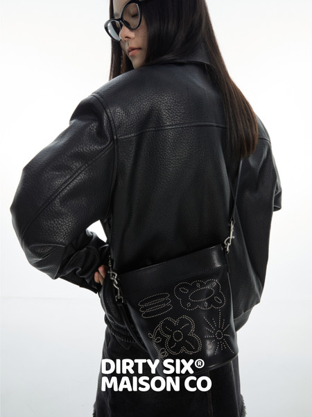 Model wearing a black leather jacket with a black crossbody bag