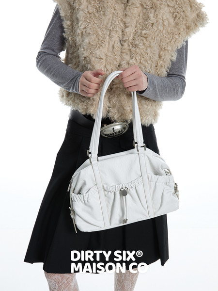 White leather handbag held by a model