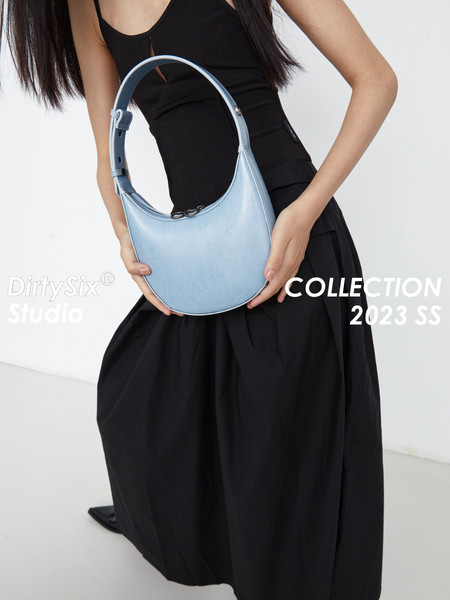 Light blue shoulder handbag worn by a model