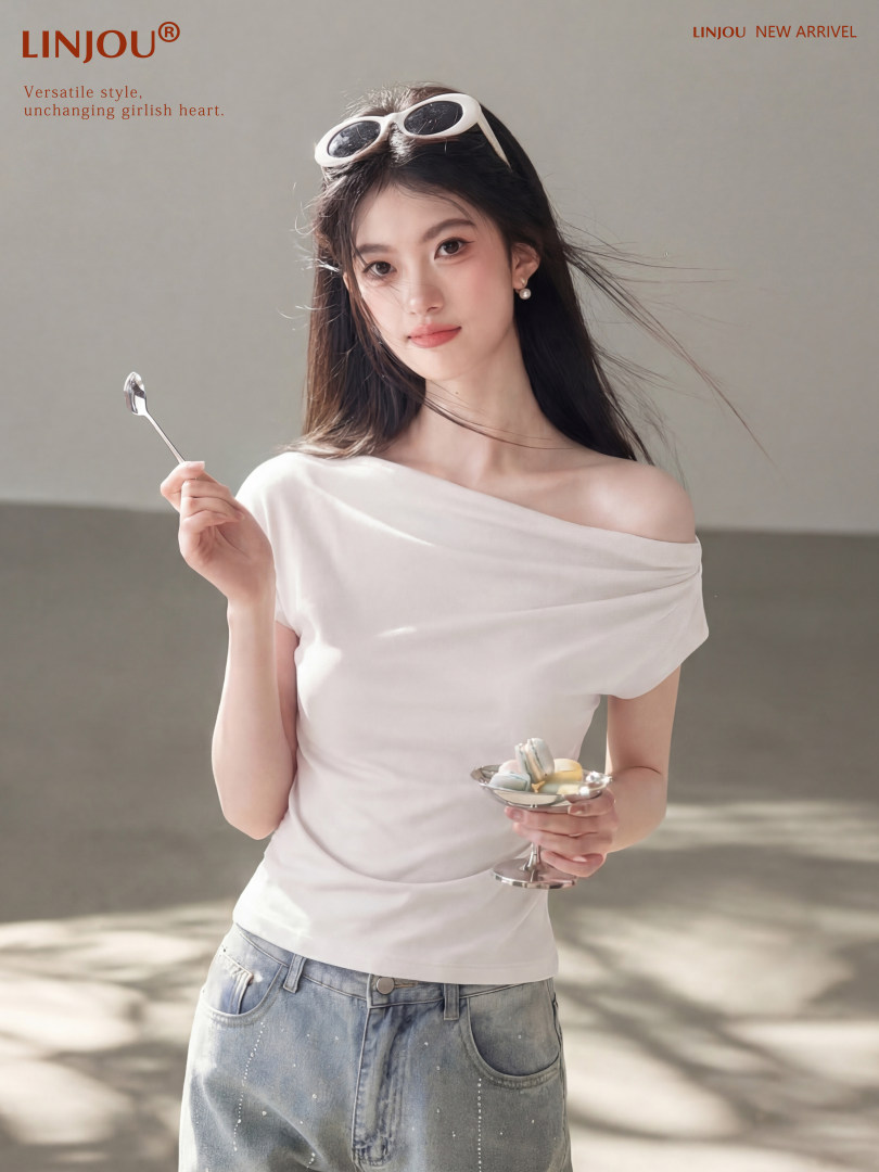 Woman wearing a white off-shoulder top with light blue jeans