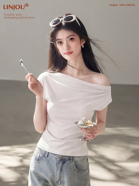 Woman wearing a white off-shoulder top with light blue jeans