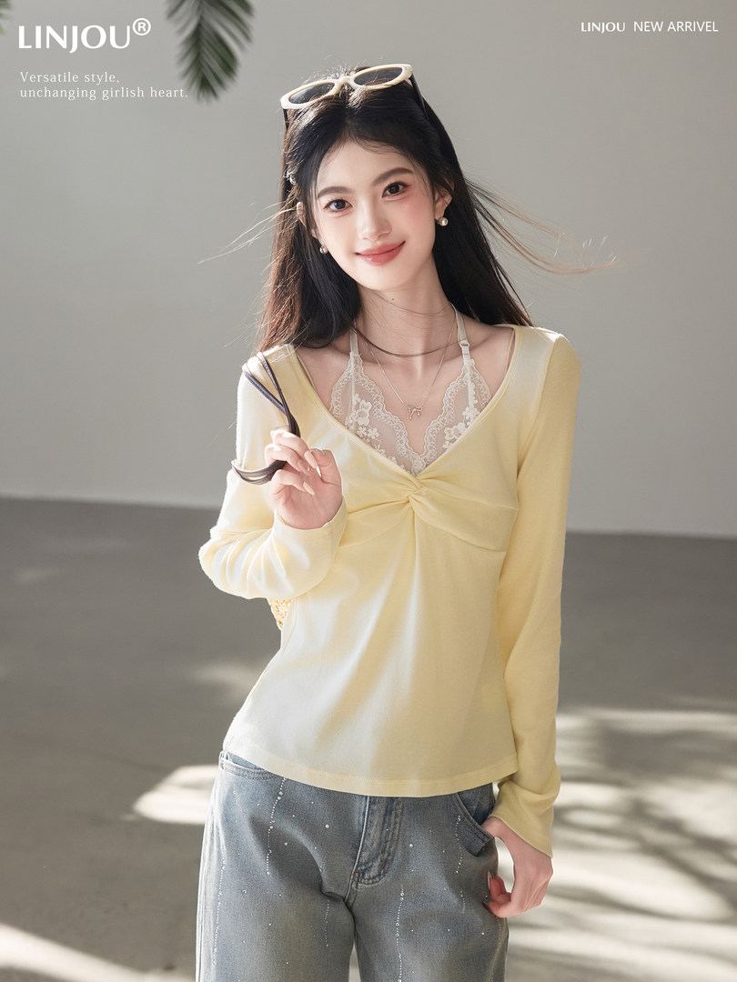 Model wearing a pale yellow long-sleeve top with lace camisole detail and jeans