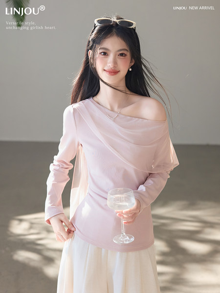 Pink off-shoulder sheer long-sleeve top worn by a model
