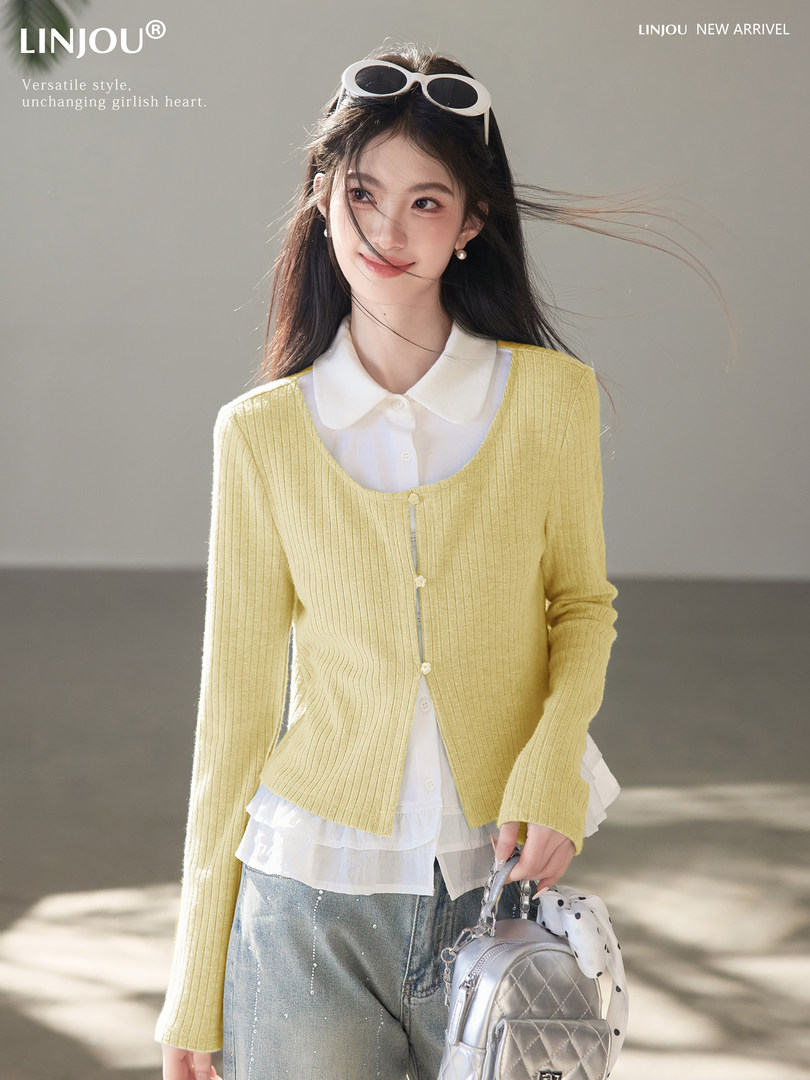 Model wearing a yellow knit cardigan over a white blouse with jeans