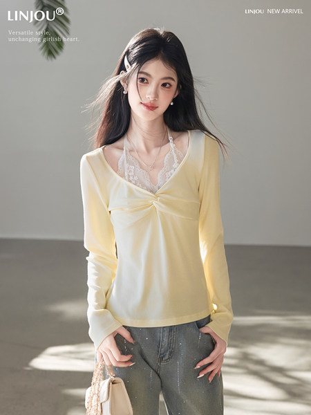 Model wearing a light yellow long-sleeve top over a lace camisole with jeans