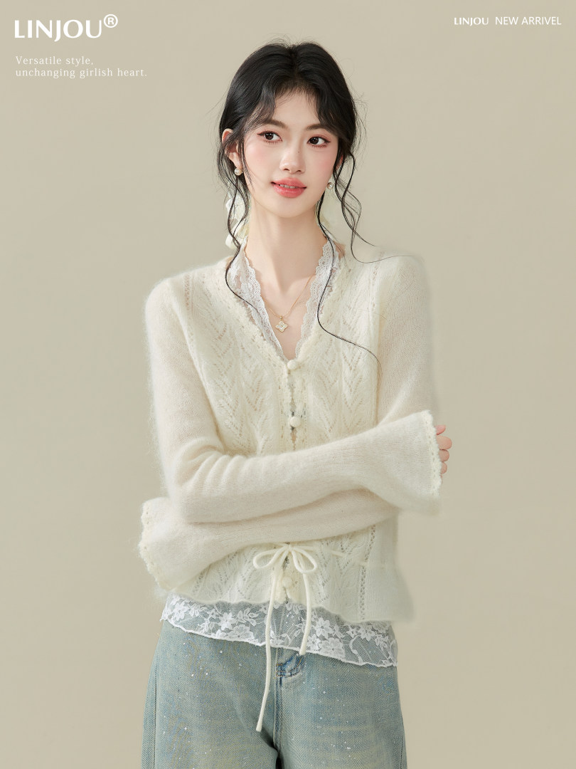 Cream lace-trim cardigan worn by a model on a plain background