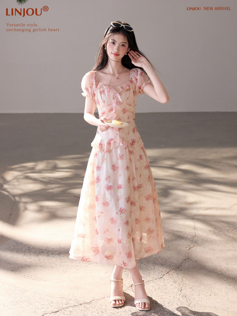 Model wearing a pink floral puff-sleeve midi dress