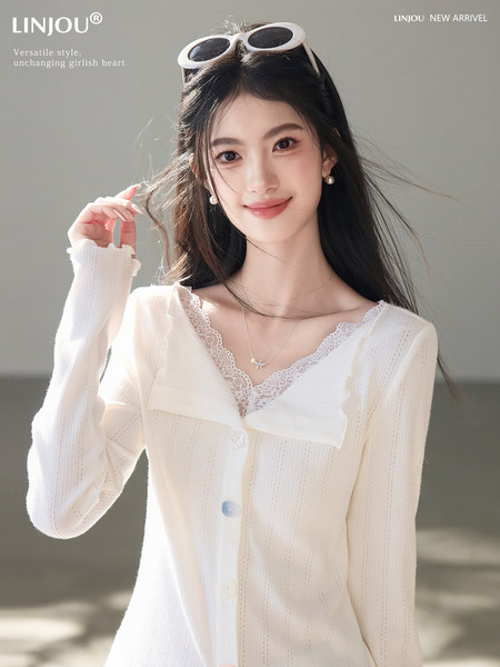 White lace-trim knit cardigan worn by a model