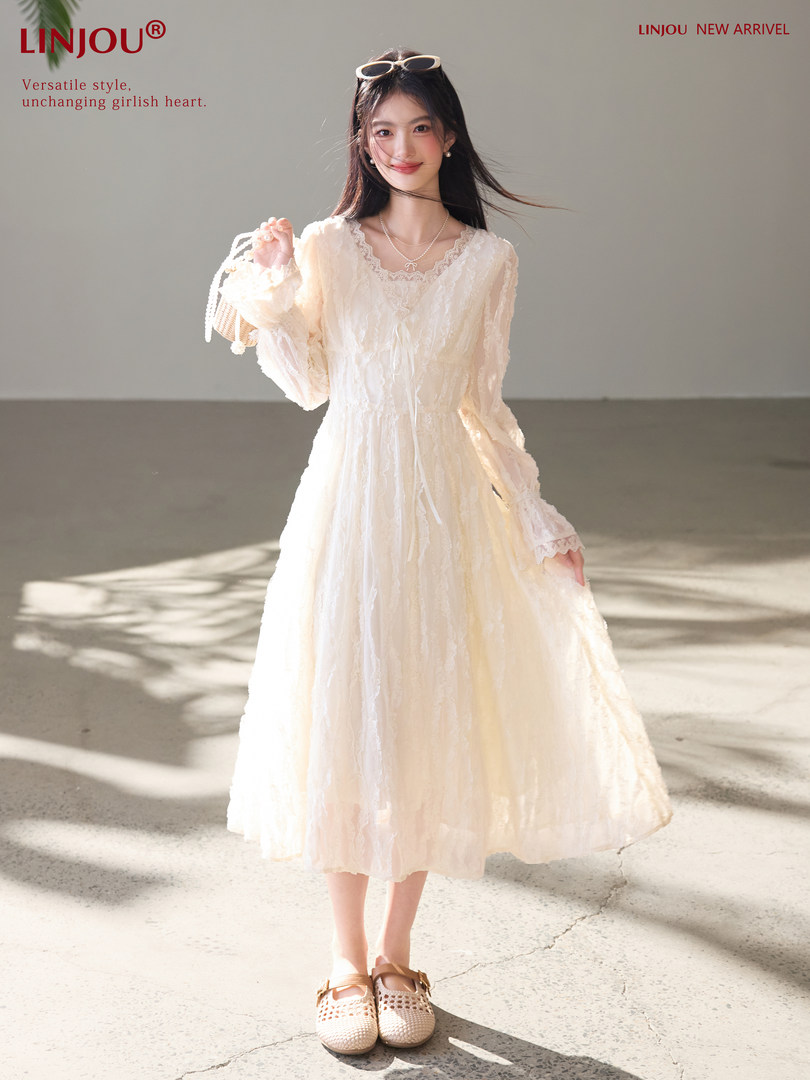 Cream lace long-sleeve midi dress worn by a model