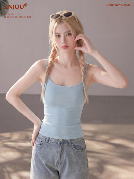 Model wearing a light blue ribbed tank top with jeans